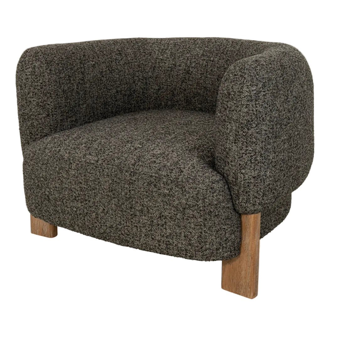 A modern upholstered armchair with ash wood legs and a soft grey fabric finish, designed to deliver both comfort and sophistication.