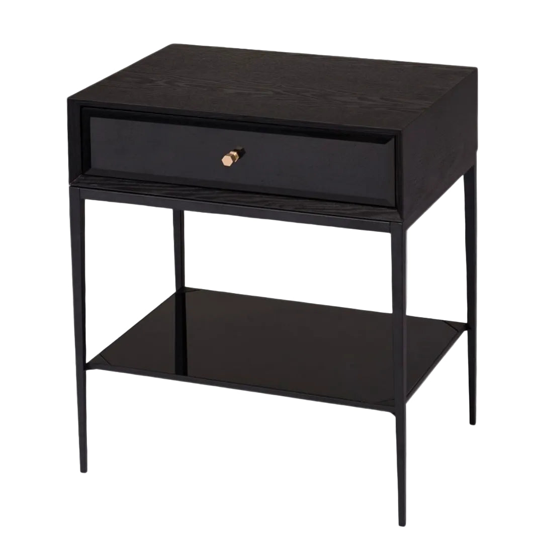 A sleek and minimalist side table with a matte black finish, antique brass trim, and a glass shelf, designed for sophisticated living spaces.