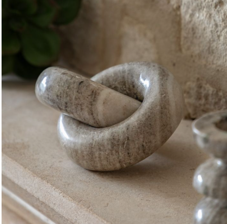 Decorative stone knot on a neutral background