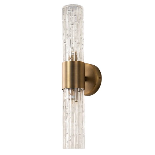A sophisticated wall lamp with a brushed brass finish, featuring double glass textured tubes.