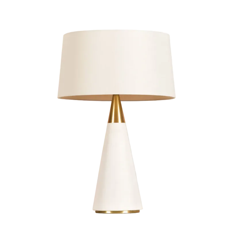 A modern table lamp with a white tapered base, a gold metallic neck, and a white drum shade, shown against a plain white background.