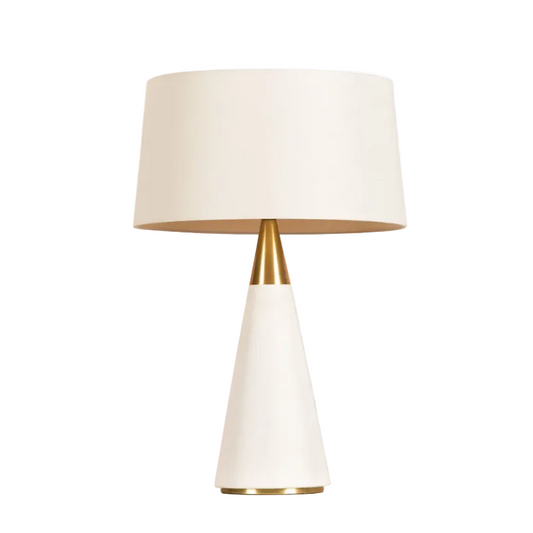 A modern table lamp with a white tapered base, a gold metallic neck, and a white drum shade, shown against a plain white background.
