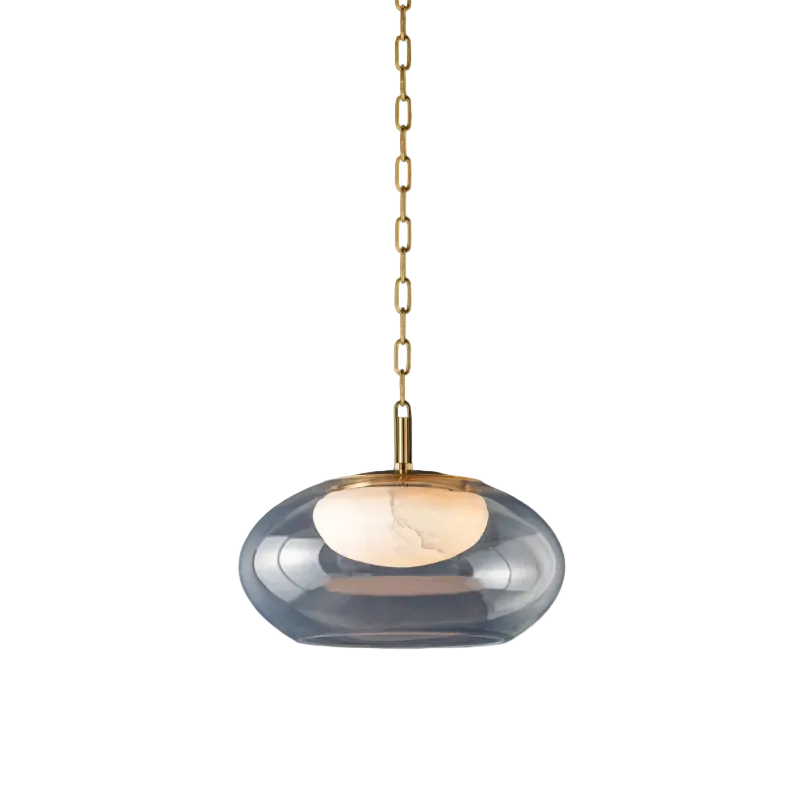 A modern pendant light with a smoky translucent glass shade, a brushed brass metal top cap, and a matching brass hanging chain against a white background.