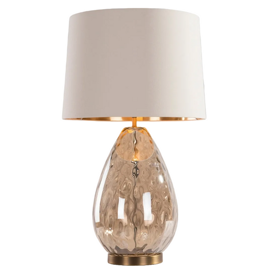 An Oris Table Lamp with a cognac glass base, antique brass detailing, and an opal fabric shade.