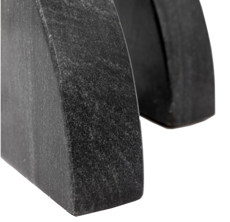 Close-up of a black rubber wedge with a textured surface on a white background