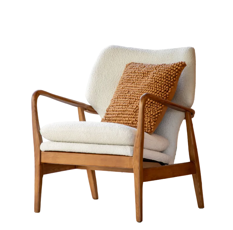 A cream upholstered armchair with button details and a solid oak wood frame, positioned in a room with wood panel walls and a window in the background.